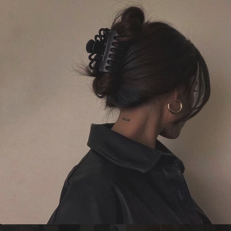 5. Classic Black Low Claw Clip Bun - Claw Clip Hairstyles