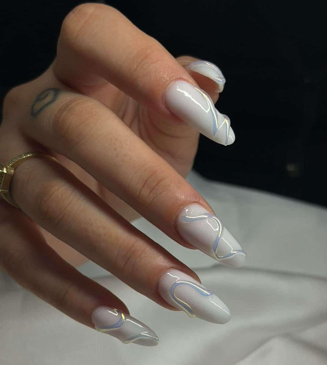 10. Glossy White Almond Nails with Iridescent Chrome Lines - fancy nail ideas