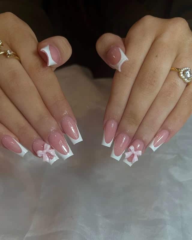 22. Blush Pink French Tip Coffin Nails with 3D Bow Accents - fancy nail ideas