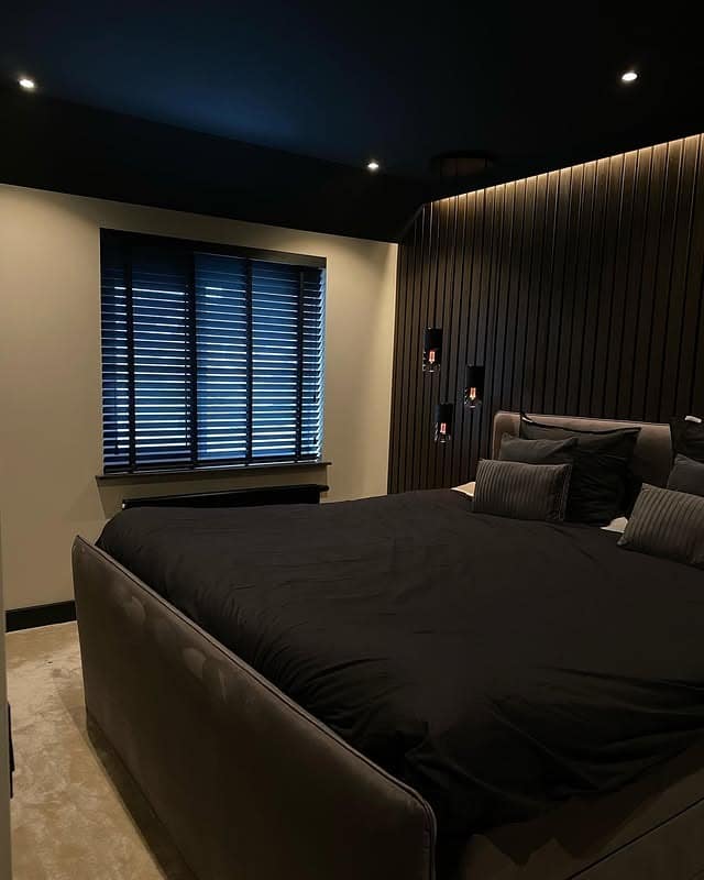 3. Modern Black Bedroom with Slatted Accent Wall - black bedroom ideas