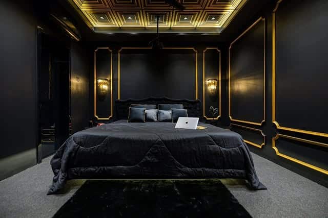 5. Luxury Black Bedroom with Gold Trim Details - black bedroom ideas