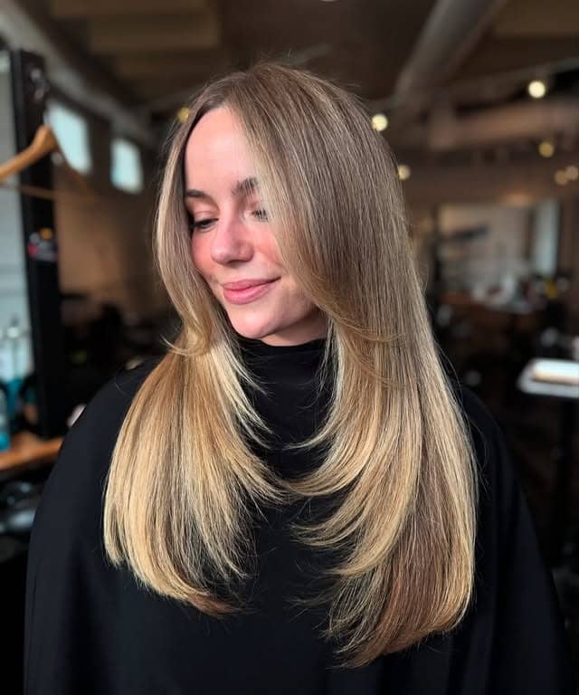 7. Sandy Blonde Layered Blowout - Winter Hair Color