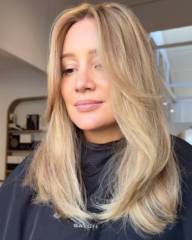 8. Champagne Blonde Feathered Layers - Winter Hair Color