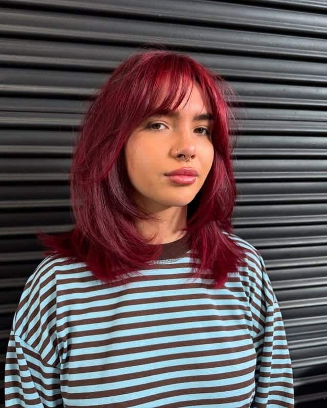 2. Layered Cherry Red Blowout with Wispy Bangs - Baddie Hairstyles