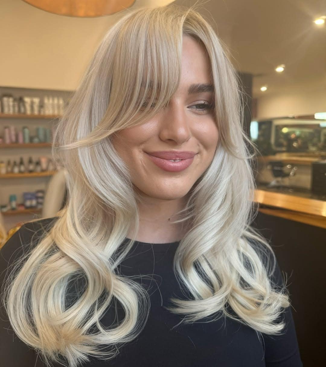 7. Platinum Blonde Glam Waves with Curtain Fringe - Baddie Hairstyles