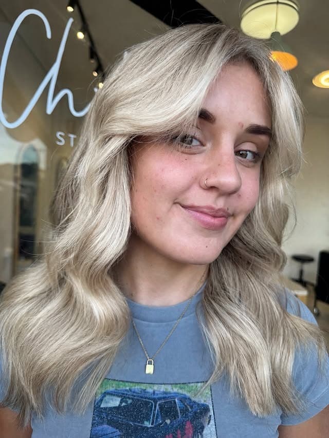 11. Soft Champagne Blonde Waves with Curtain Bangs - Baddie Hairstyles
