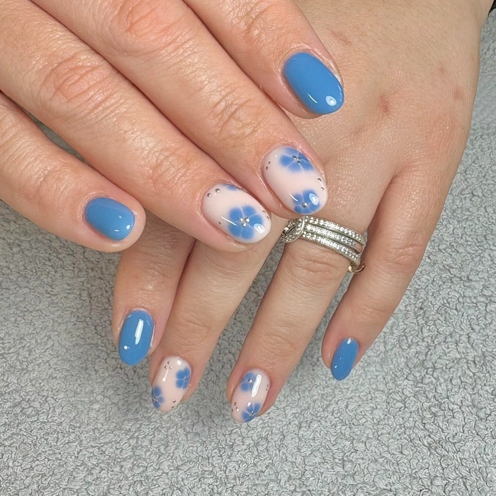 12. Sky Blue Floral Short Oval Nails - march nail ideas