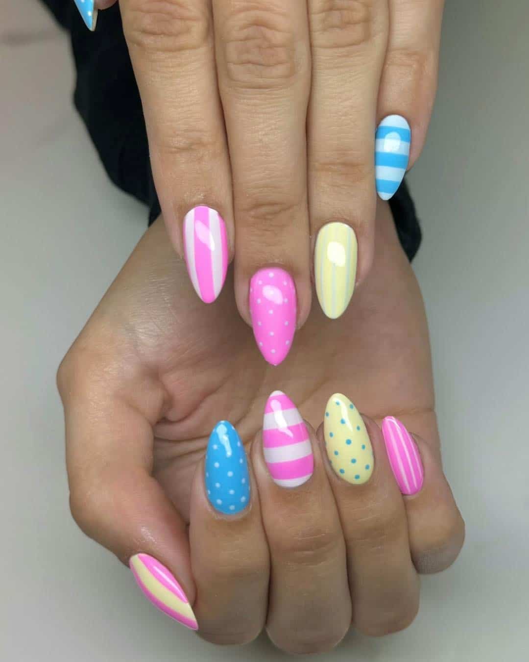 18. Pastel Pink Blue and Yellow Pattern Almond Nails - march nail ideas