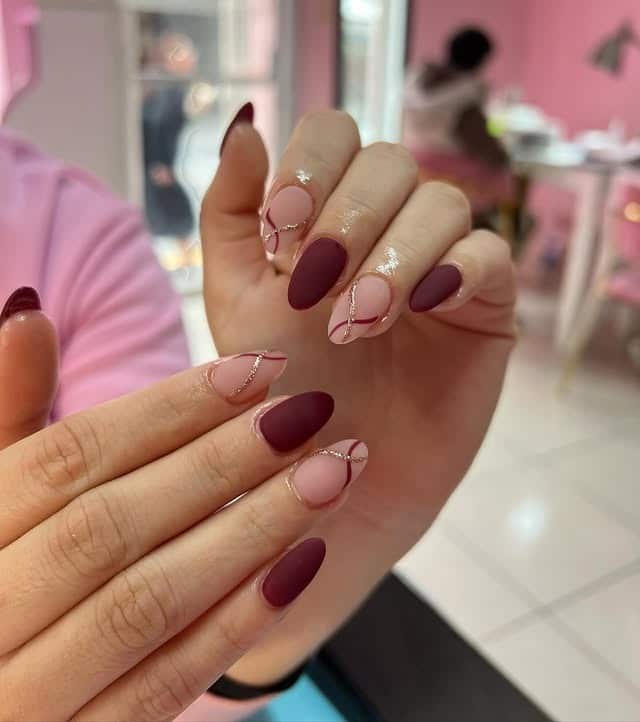 2. Matte Burgundy Swirl Almond Nails - matte nail ideas