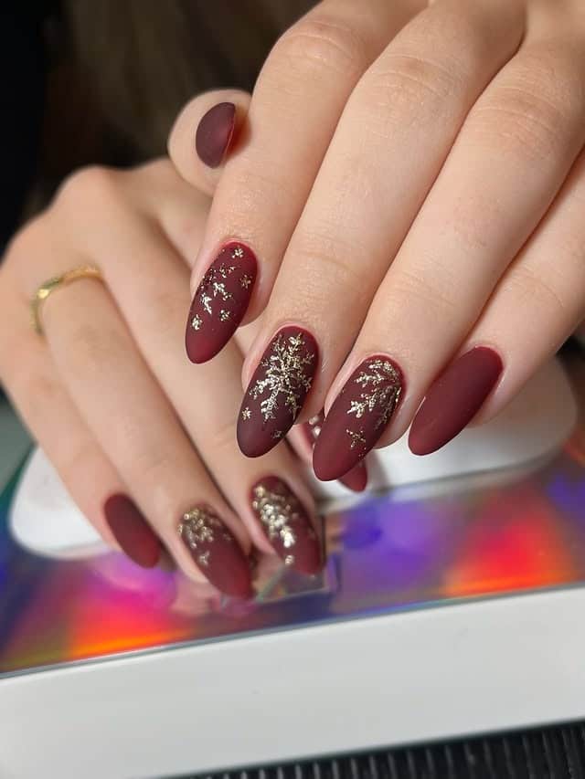18. Matte Burgundy Snowflake Almond Nails - matte nail ideas