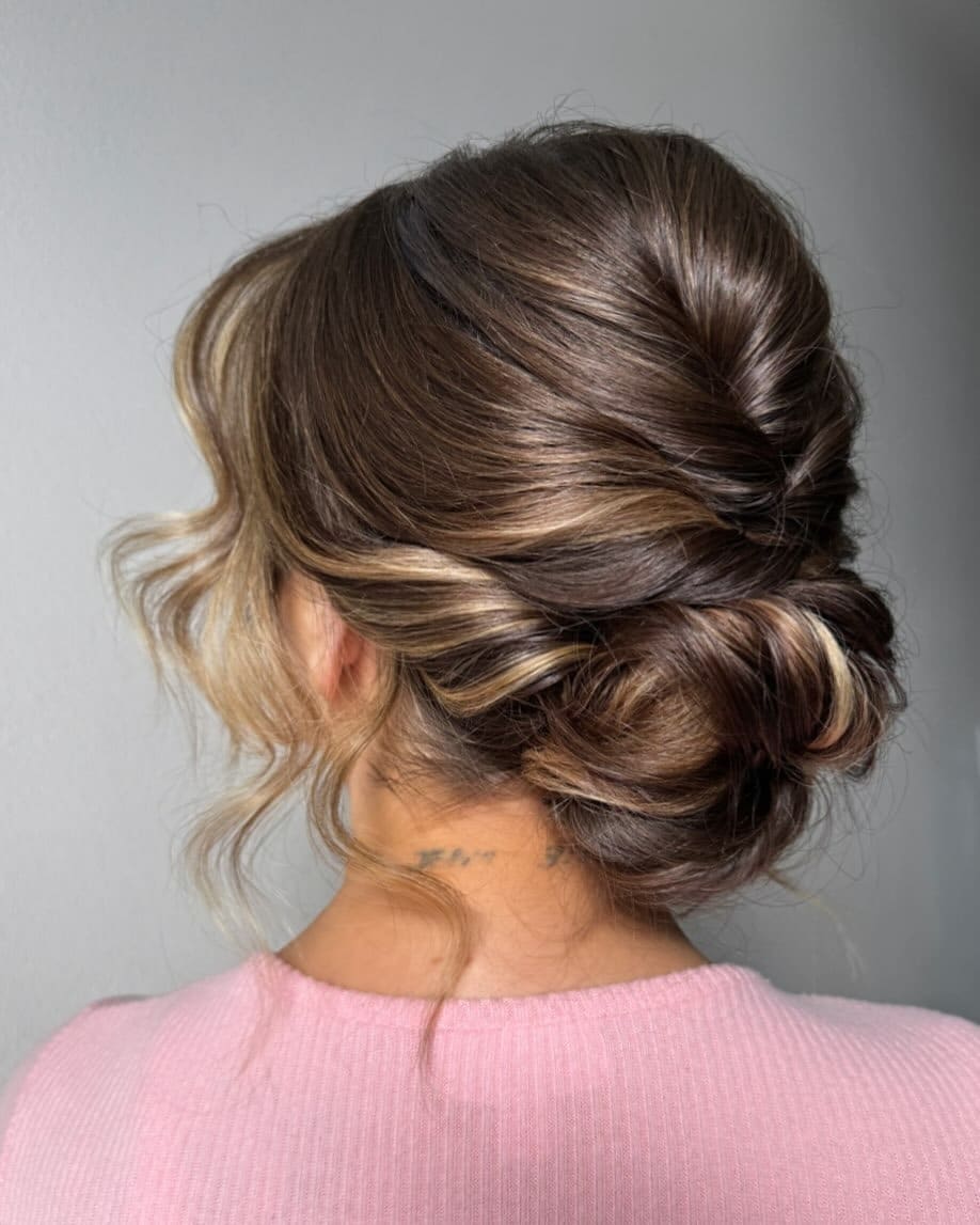 2. Twisted Low Bun with Espresso Brown and Blonde Money Piece - Bun Hairstyles