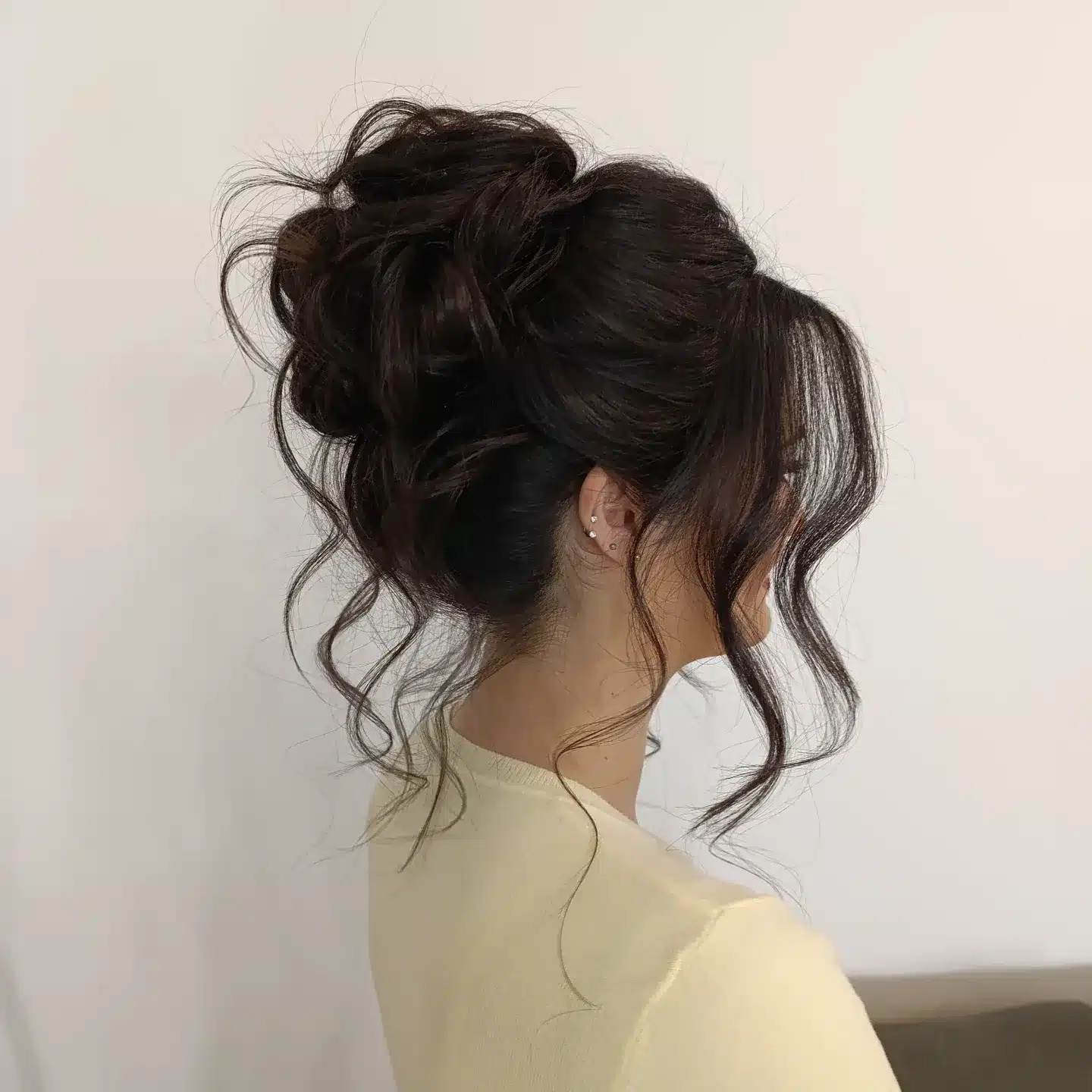 5. Loose Textured Bun with Soft Black Hair - Bun Hairstyles