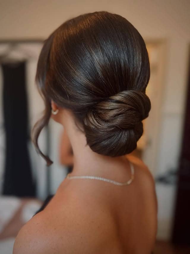 7. Classic Sleek Low Bun with Dark Espresso Brown Hair - Bun Hairstyles