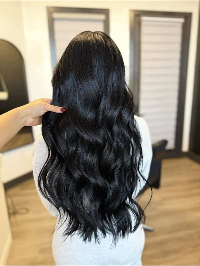 7. Soft Black Long Feathered Layers - Soft Black Hair Color