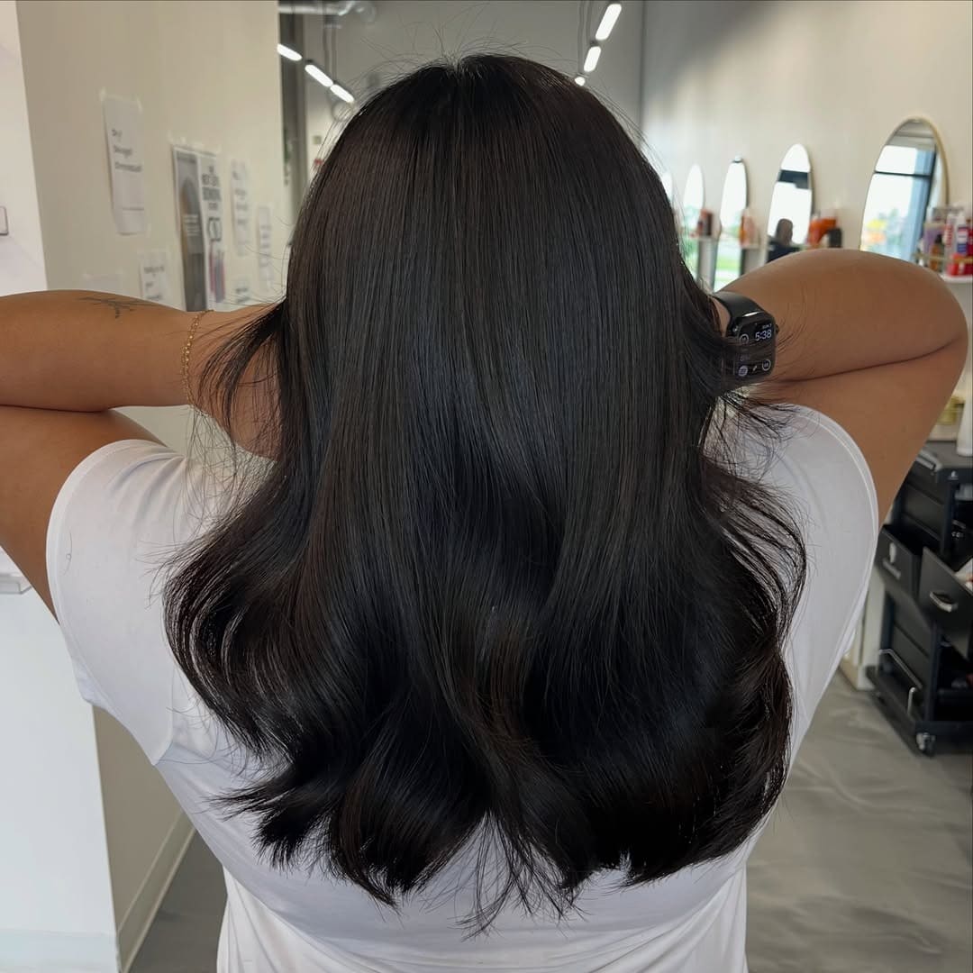 10. Soft Black Medium-Length Layered Cut - Soft Black Hair Color