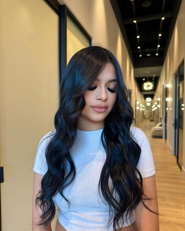 14. Soft Black Long Glam Waves with Curtain Bangs - Soft Black Hair Color
