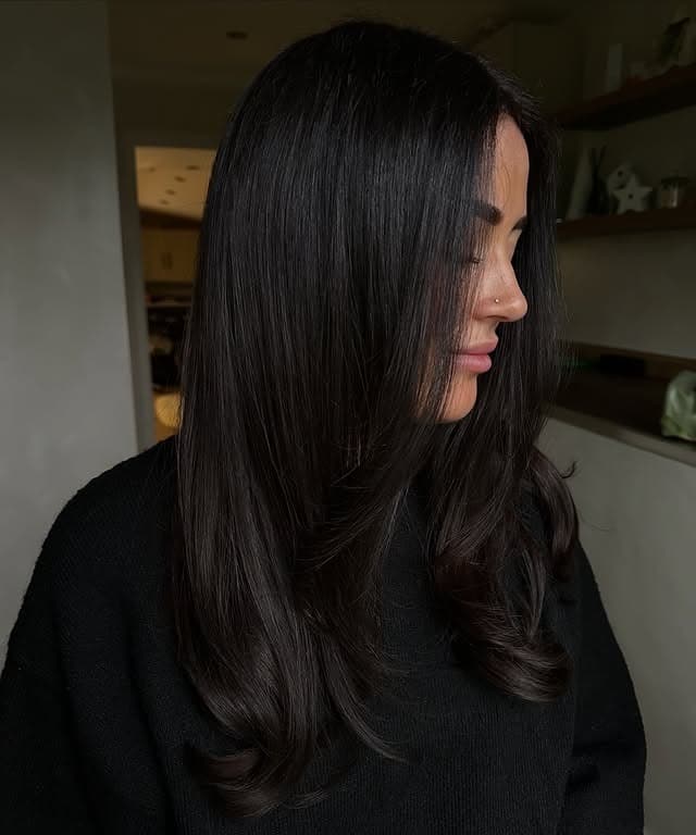 17. Soft Black Sleek Layers with Face-Framing Pieces - Soft Black Hair Color