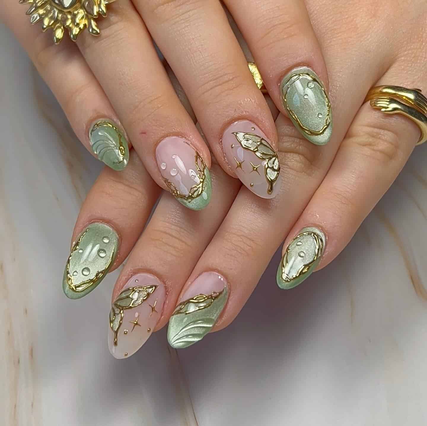 15. Sage Green Gilded Butterfly Almond Nails - butterfly nail ideas