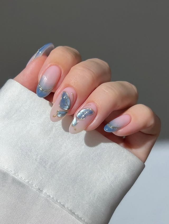 19. Powder Blue Chrome Butterfly Accent Nails - butterfly nail ideas