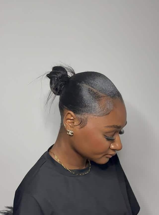 4. Jet Black Sleek Mini Bun with Sculpted Edges - Sleek Hairstyles