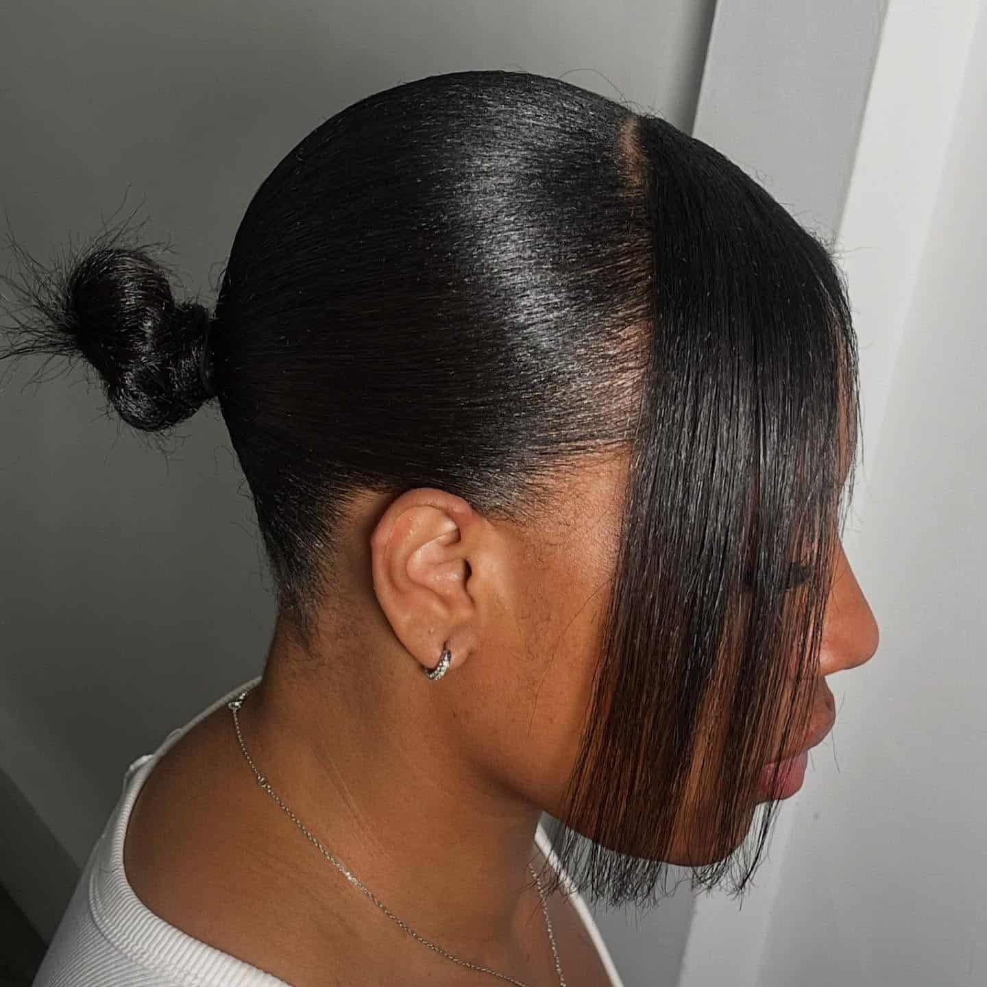 5. Dark Espresso Sleek Bun with Long Side Bang - Sleek Hairstyles