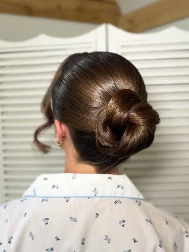 14. Chestnut Brown Sleek Sculpted Low Bun - Sleek Hairstyles