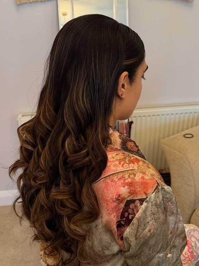 17. Warm Brunette Sleek Side-Parted Curls - Sleek Hairstyles