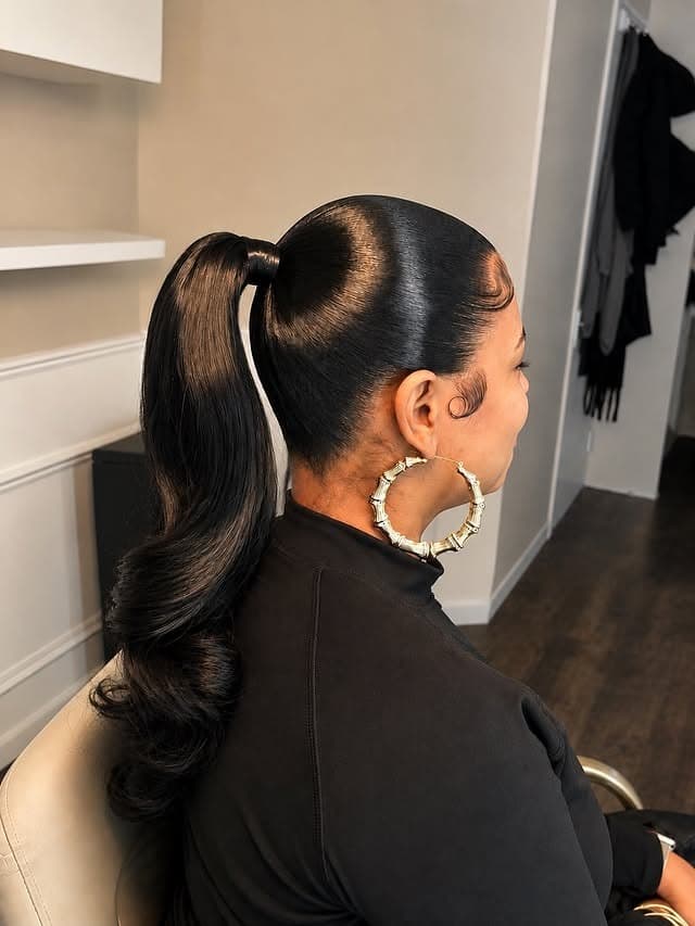 20. Jet Black Sleek High Ponytail with Curled Ends - Sleek Hairstyles