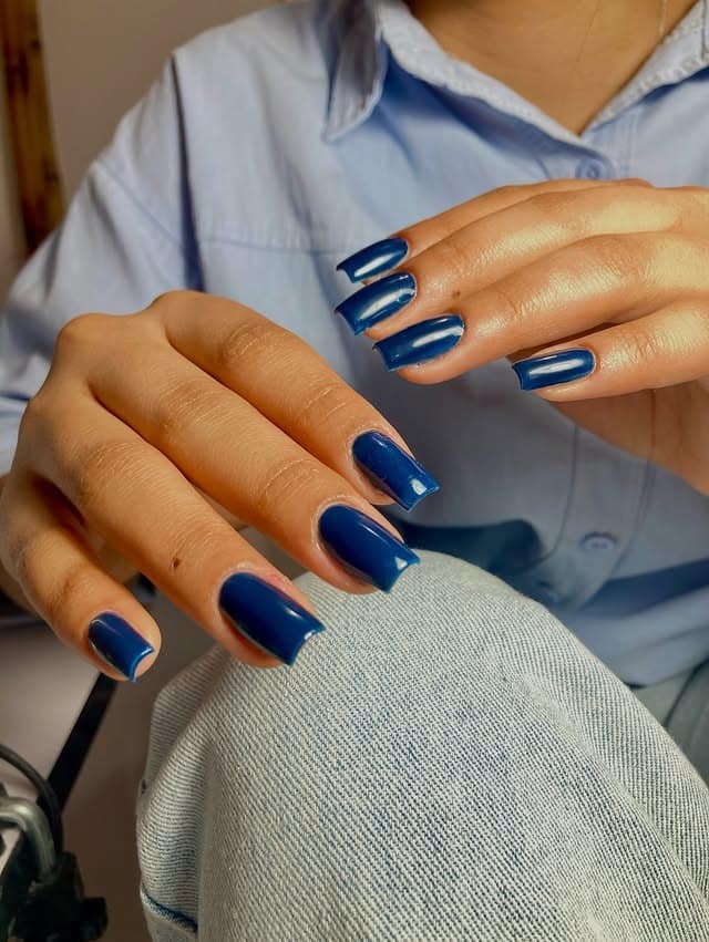 2. Deep Ocean Blue Coffin Nails - dark blue nail ideas