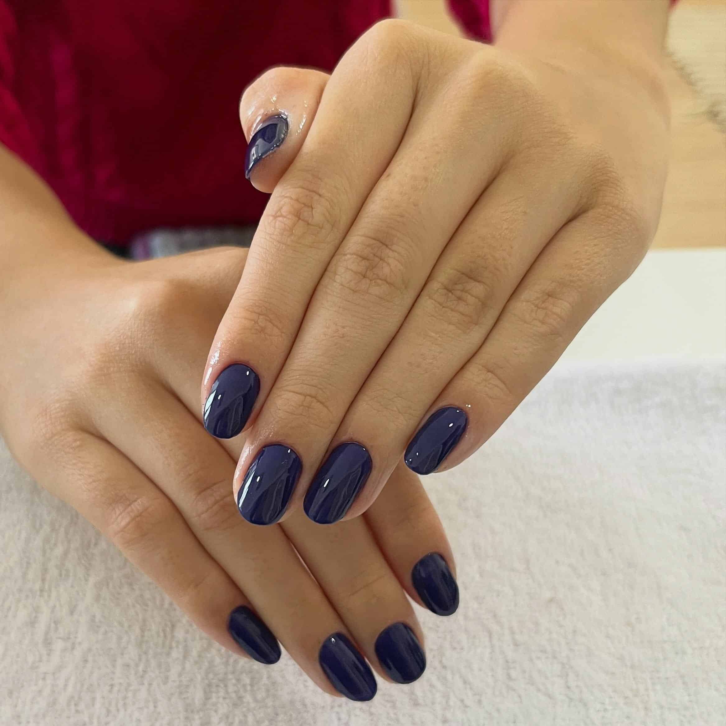 4. Inky Navy Short Oval Nails - dark blue nail ideas