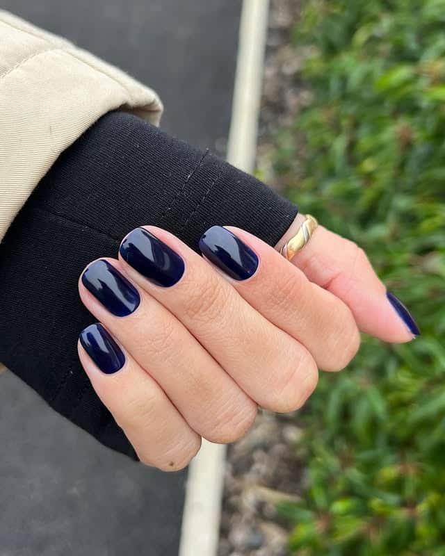 17. Inky Navy Short Oval Nails - dark blue nail ideas