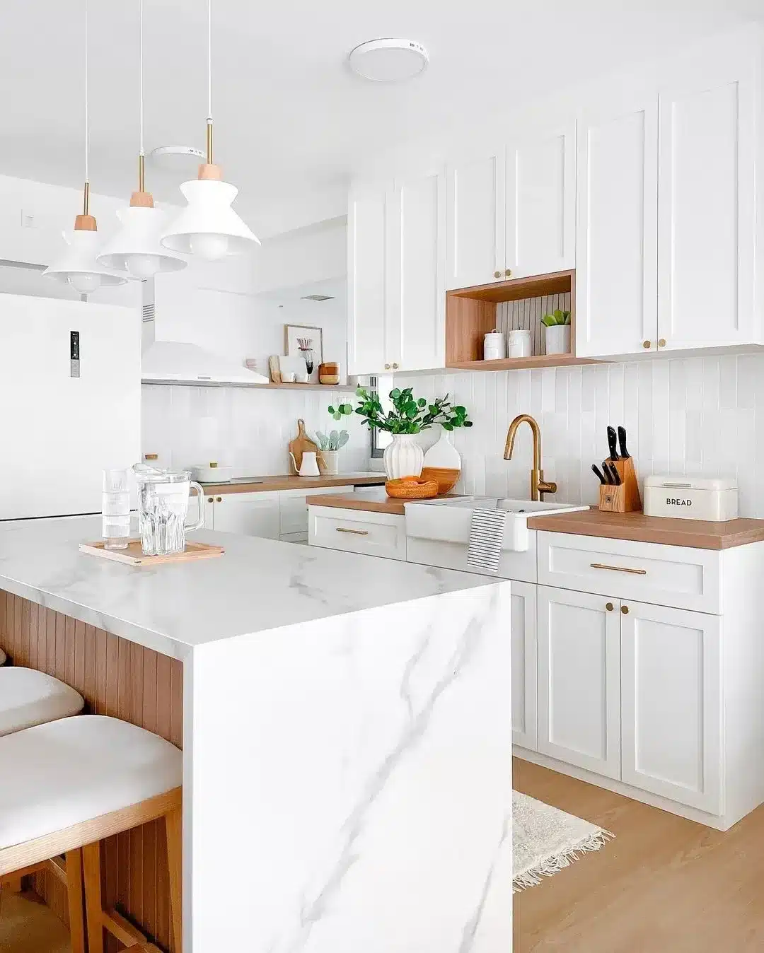 1. Warm White Cabinets with Natural Wood and Brass - white cabinets kitchen ideas