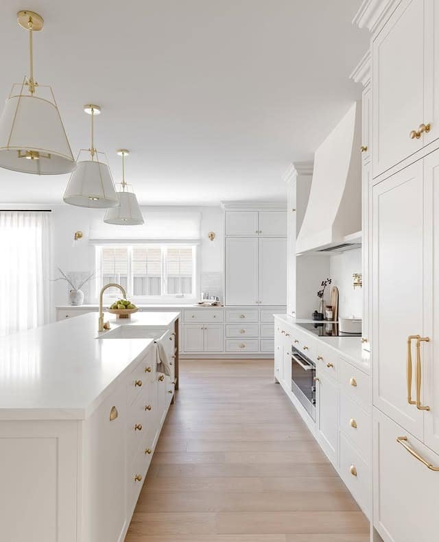 2. Soft White Cabinets with Champagne Brass Details - white cabinets kitchen ideas