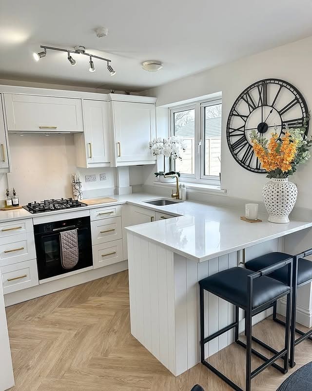 7. Bright White Cabinets with Black and Brass Accents - white cabinets kitchen ideas