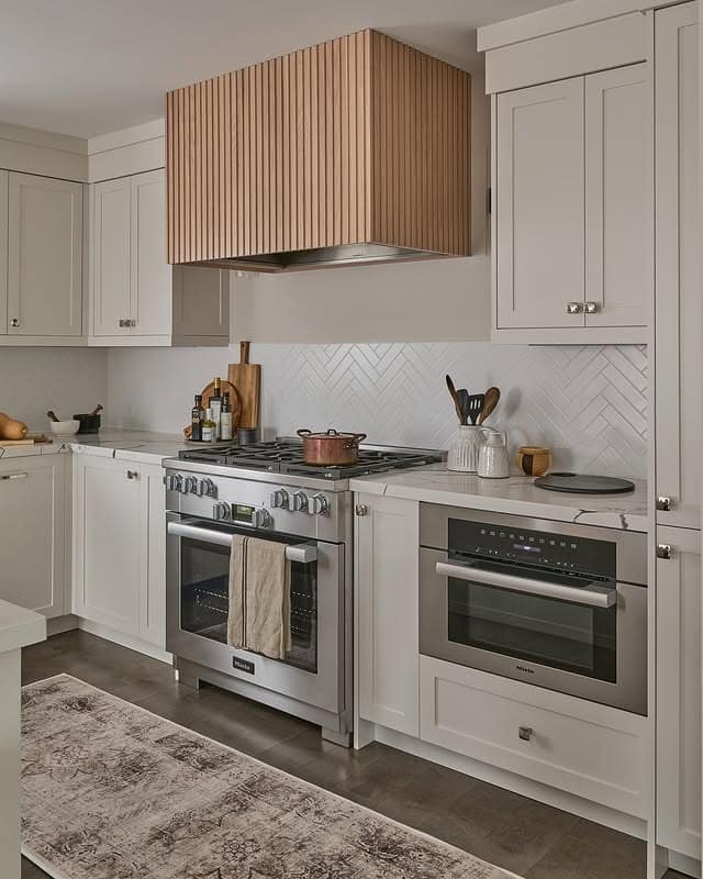 11. Warm White Shaker Cabinets with Slatted Oak Range Hood - white cabinets kitchen ideas