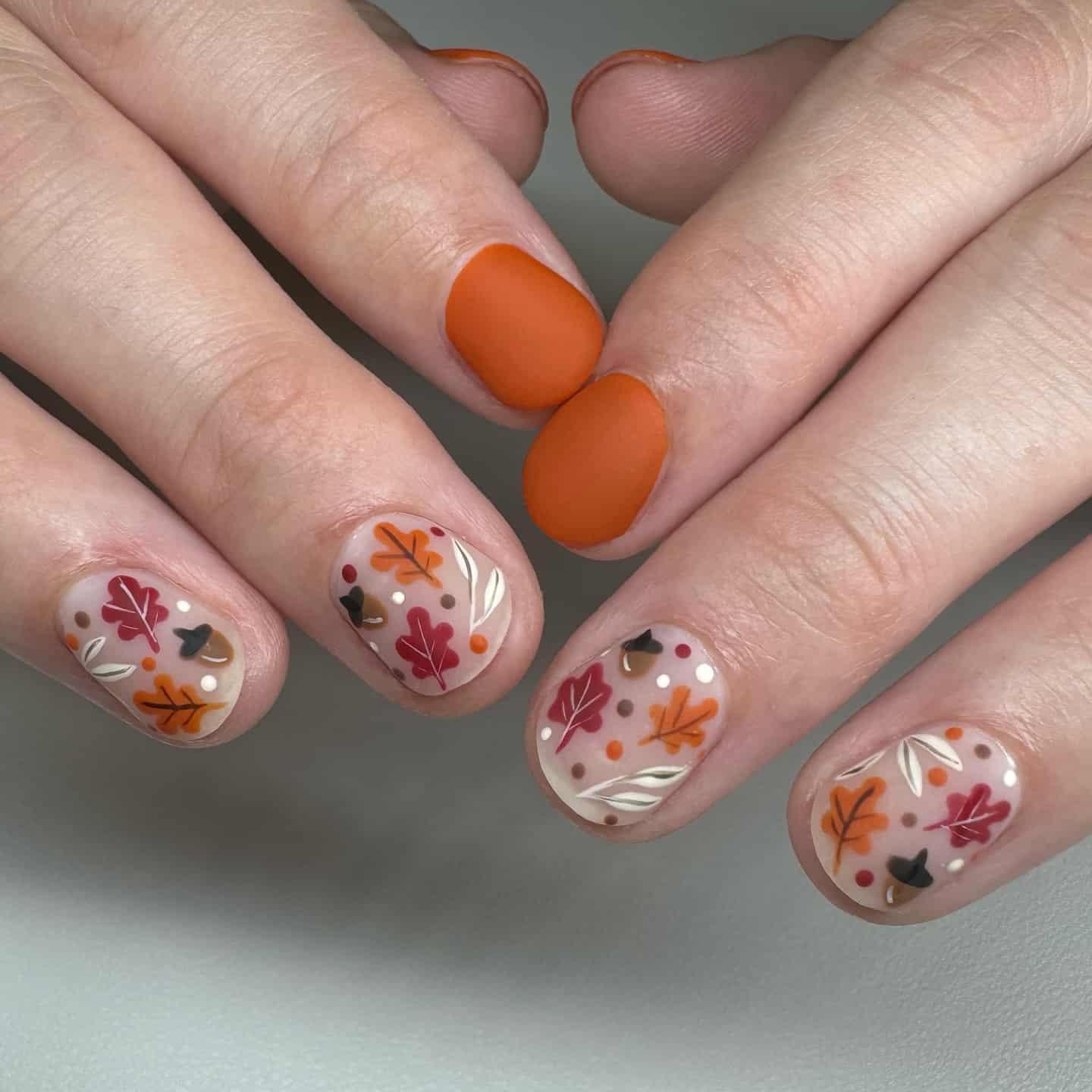 10. Matte Orange Falling Leaf Short Nails - fall leaf nail ideas
