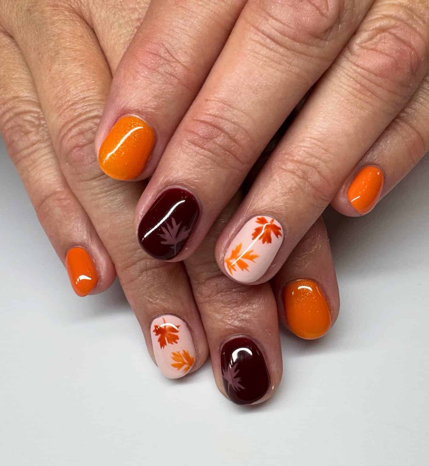 11. Orange and Burgundy Maple Leaf Short Nails - fall leaf nail ideas