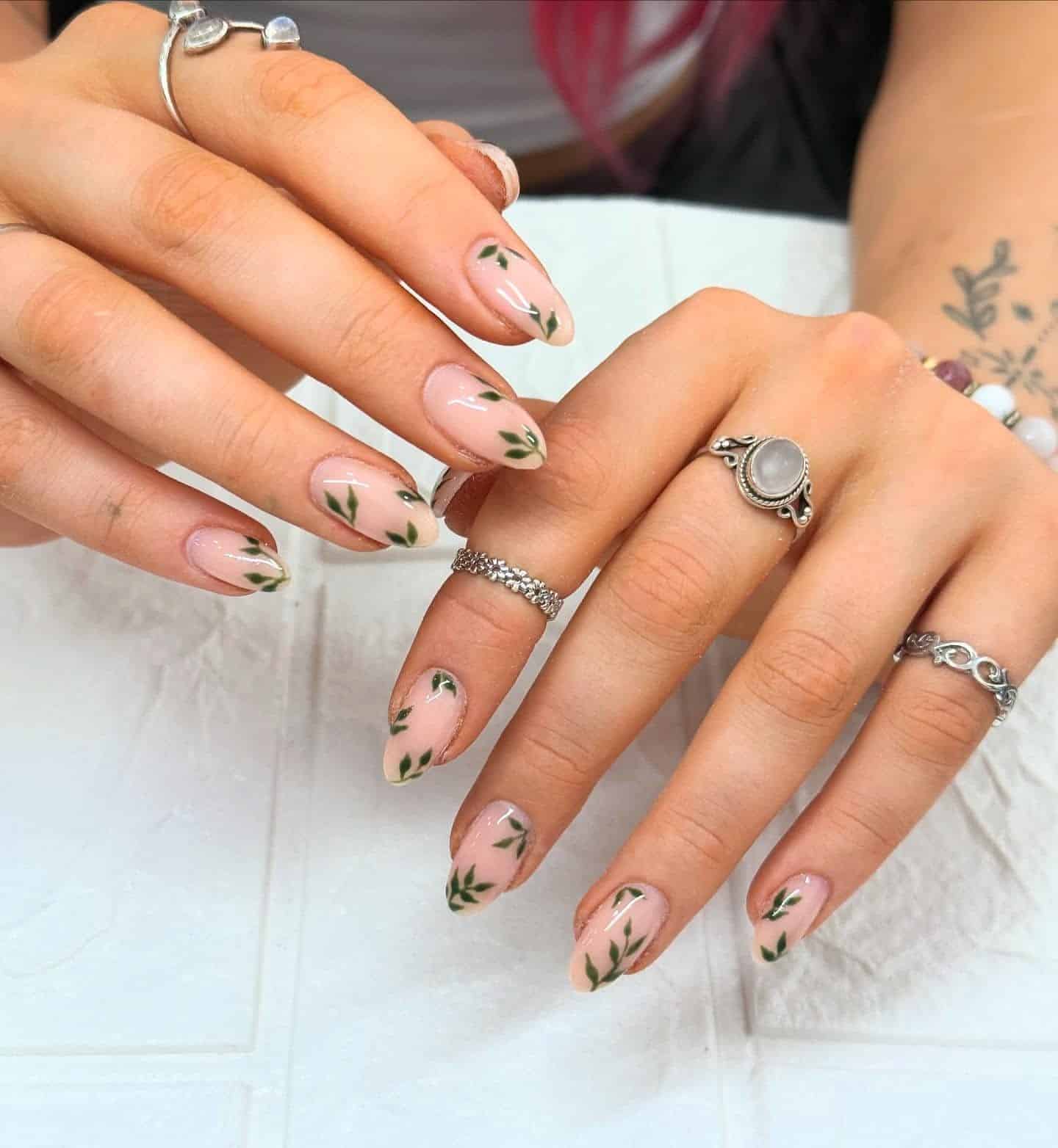18. Nude and Forest Green Leaf Almond Nails - fall leaf nail ideas