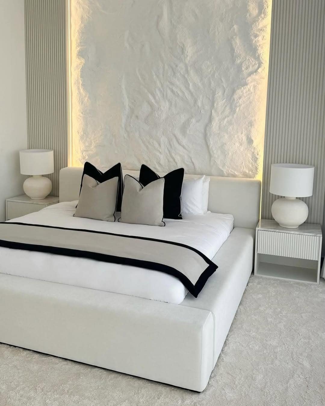 4. Black, White and Soft Gray Bedroom with Backlit Textured Feature Wall - elegant bedroom ideas