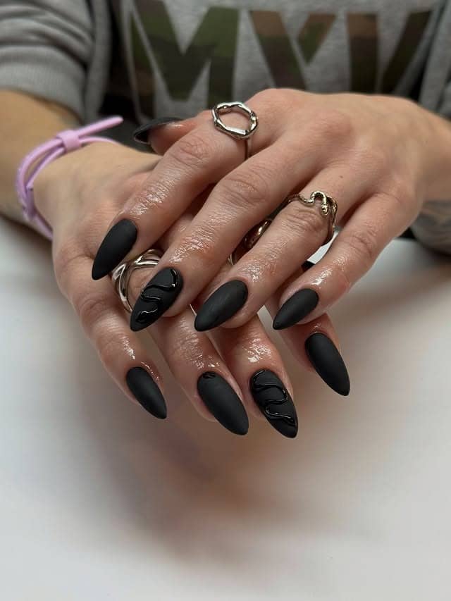 6. Matte Black Almond Nails with Glossy Waves - matte black nail ideas