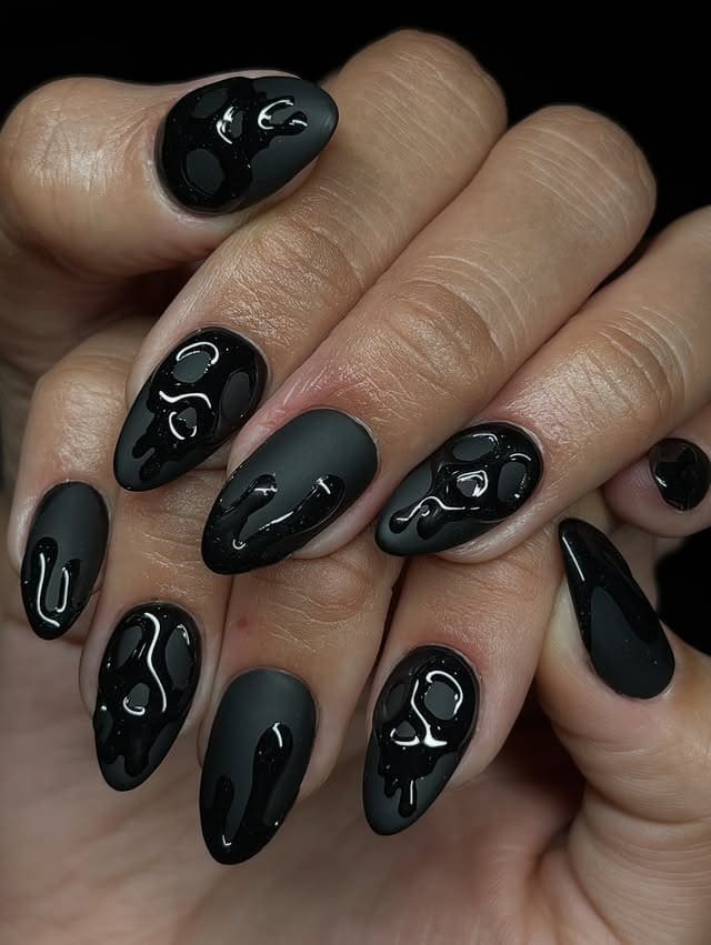7. Matte Black Drip Almond Nails - matte black nail ideas