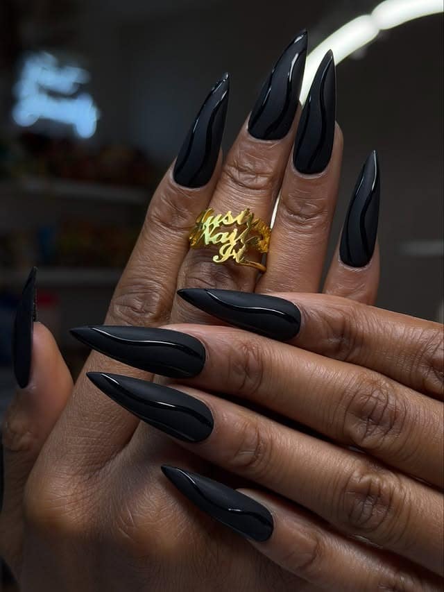 11. Matte Black Stiletto Nails with Glossy Waves - matte black nail ideas