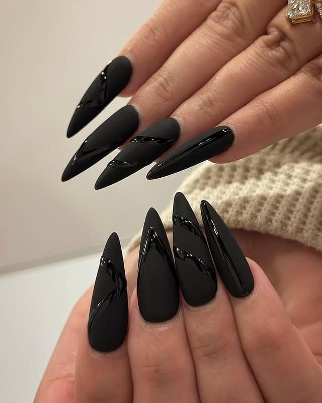 16. Matte Black Stiletto Nails with Glossy Geometric Accents - matte black nail ideas