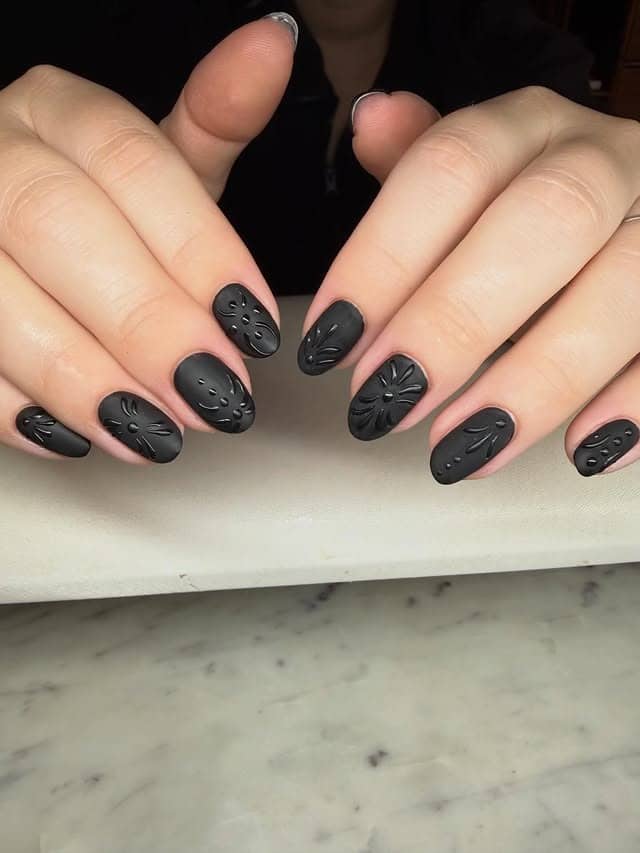18. Matte Black Embossed Floral Short Nails - matte black nail ideas