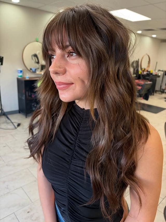 15. Rich Brunette Waves with Full Fringe - Fringe Hairstyles