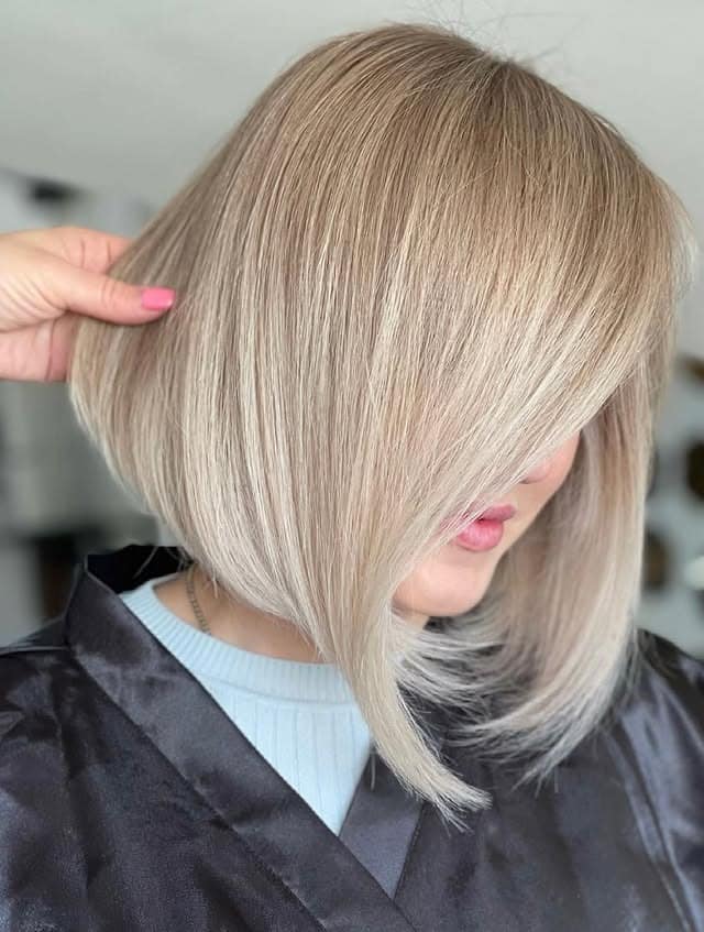4. Pearl Blonde Angled Bob with Side Fringe - Angled Bob Hairstyles