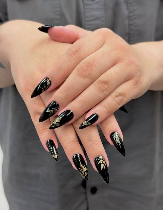 2. Black and Gold Botanical Stiletto Nails - nail ideas for long nails