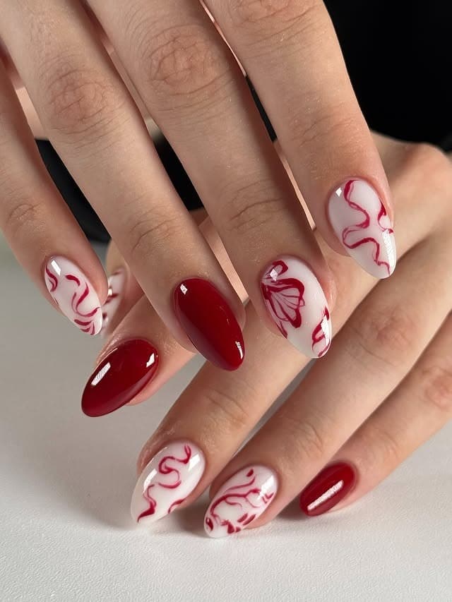 4. Ruby Red Floral Swirl Almond Nails - red and white nail ideas