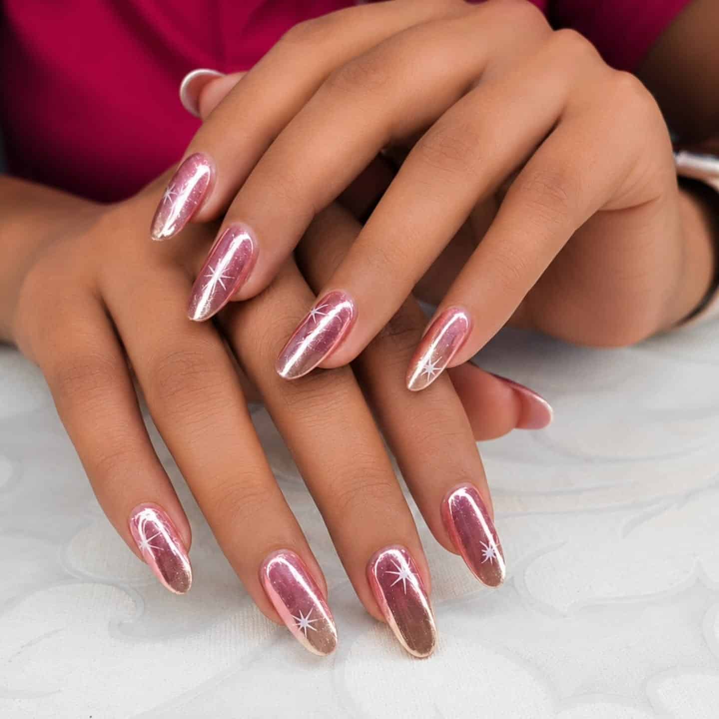 8. Rose Gold Chrome Starburst Almond Nails - rose gold nail ideas