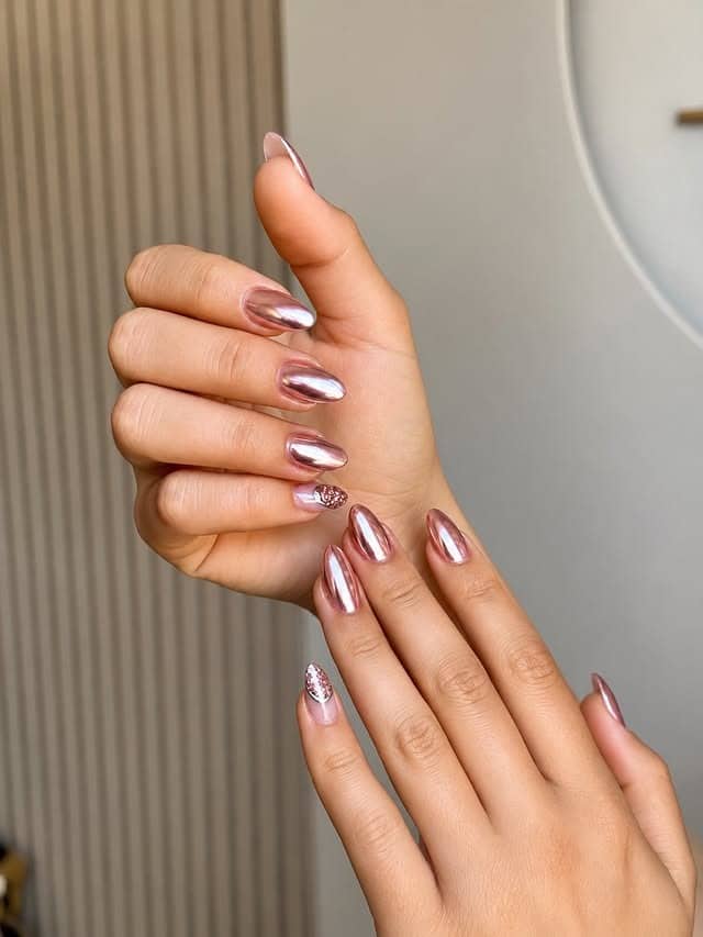 9. Rose Gold Chrome Almond Nails With Glitter Accents - rose gold nail ideas